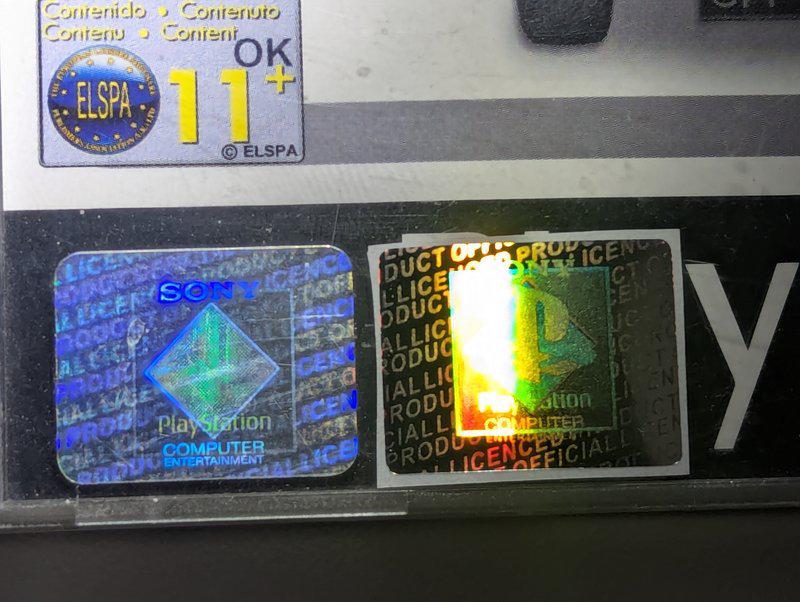 A genuine Hologram A (left) showing the Sony Computer Entertainment logo on its own, next to the fake (right) showing both logos merged.