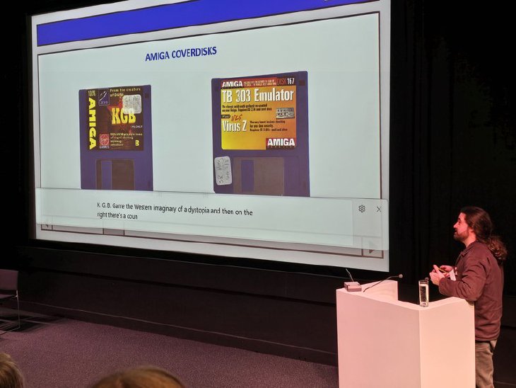 A speaker presenting a slide of Amiga magazine cover disks at Playable Heritage 2026